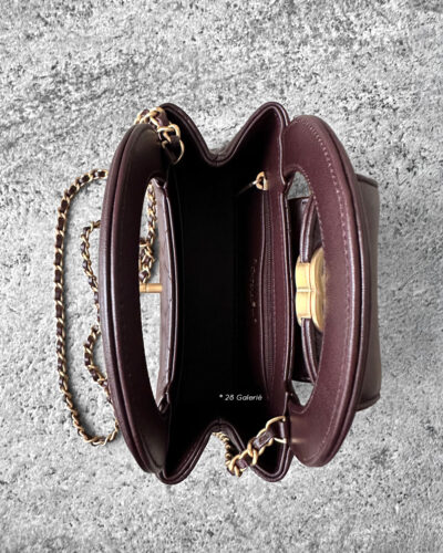 Chanel Dark Brown Mini Kelly Shopping Tote in shiny calfskin leather with gold hardware. A chic, structured design that blends elegance with everyday style.