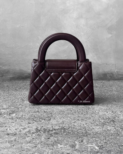 Chanel Dark Brown Mini Kelly Shopping Tote in shiny calfskin leather with gold hardware. A chic, structured design that blends elegance with everyday style.