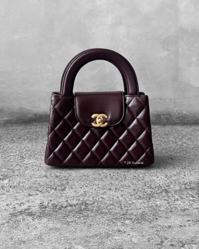 Chanel Dark Brown Mini Kelly Shopping Tote in shiny calfskin leather with gold hardware. A chic, structured design that blends elegance with everyday style.