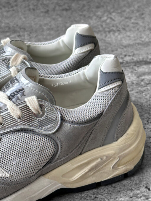 Golden Goose Dad-Star sneakers in suede and silver mesh, combining retro-inspired style with signature distressed detailing.