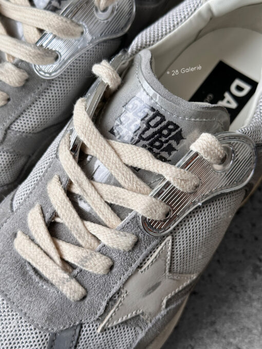Golden Goose Dad-Star sneakers in suede and silver mesh, combining retro-inspired style with signature distressed detailing.