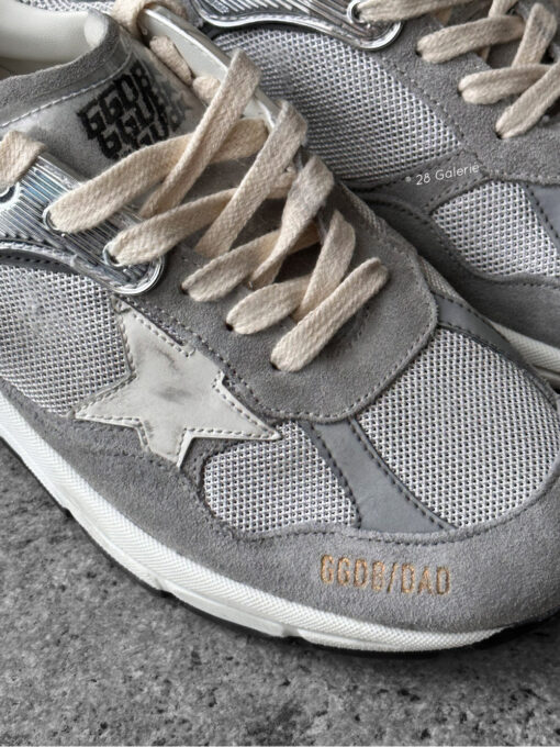 Golden Goose Dad-Star sneakers in suede and silver mesh, combining retro-inspired style with signature distressed detailing.