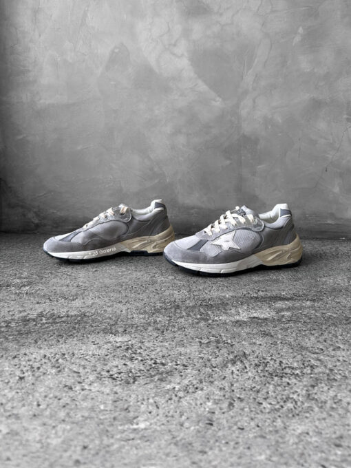 Golden Goose Dad-Star sneakers in suede and silver mesh, combining retro-inspired style with signature distressed detailing.