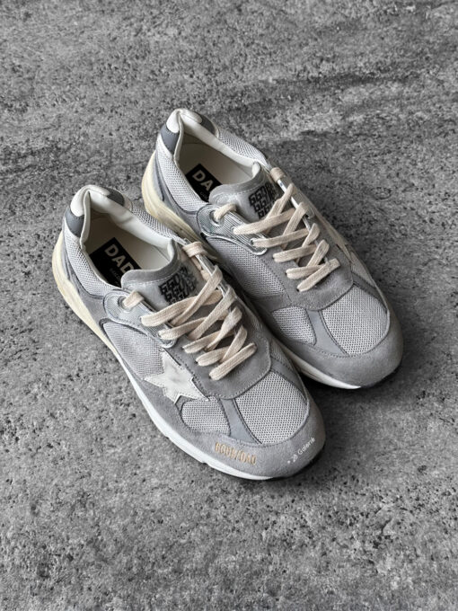 Golden Goose Dad-Star sneakers in suede and silver mesh, combining retro-inspired style with signature distressed detailing.
