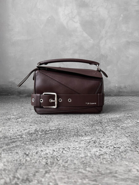 Loewe Small Dark Brownie Puzzle Biker Bag in calfskin leather, blending the iconic Puzzle design with bold biker-inspired detailing.