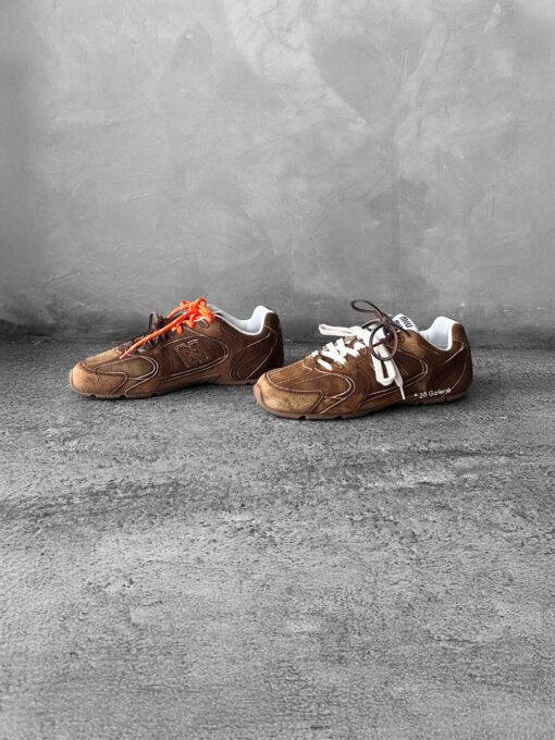 Miu Miu x New Balance 530 SL sneakers in cinnamon suede leather, merging sporty design with luxury craftsmanship.