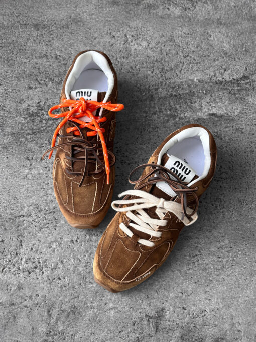 Miu Miu x New Balance 530 SL sneakers in cinnamon suede leather, merging sporty design with luxury craftsmanship.