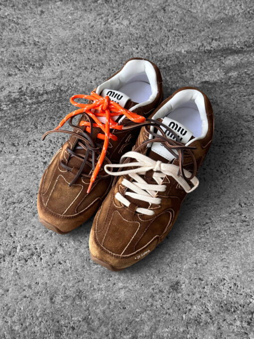 Miu Miu x New Balance 530 SL sneakers in cinnamon suede leather, merging sporty design with luxury craftsmanship.