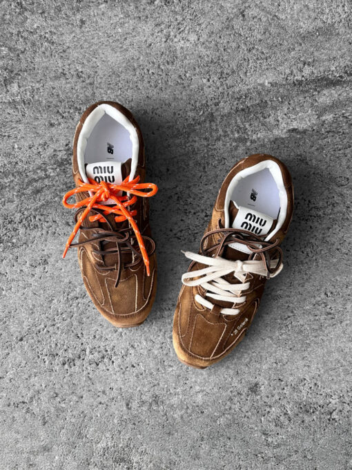 Miu Miu x New Balance 530 SL sneakers in cinnamon suede leather, merging sporty design with luxury craftsmanship.