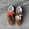 Miu Miu x New Balance 530 SL sneakers in cinnamon suede leather, merging sporty design with luxury craftsmanship.