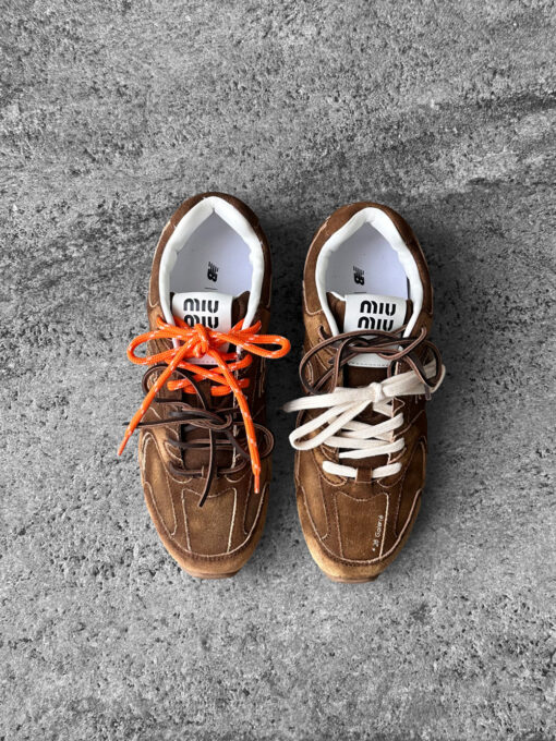 Miu Miu x New Balance 530 SL sneakers in cinnamon suede leather, merging sporty design with luxury craftsmanship.