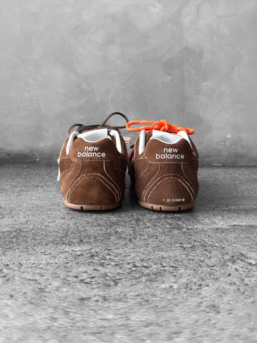 Miu Miu x New Balance 530 SL sneakers in cinnamon suede leather, merging sporty design with luxury craftsmanship.
