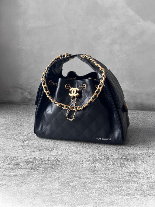 Small Black C25 Quilted Caviar bag with aged gold-tone hardware. A classic, compact design that exudes timeless elegance and versatile style.