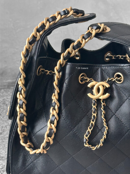 Small Black C25 Quilted Caviar bag with aged gold-tone hardware. A classic, compact design that exudes timeless elegance and versatile style.