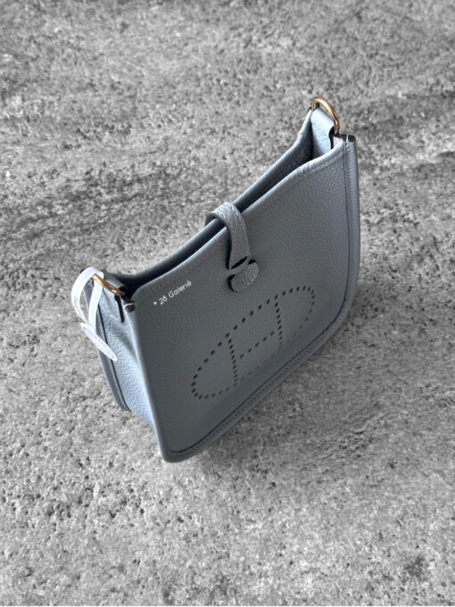 Hermès Bleu Glacier Evelyne 16 Amazone Bag, a compact crossbody in Clemence leather with signature perforated H logo and canvas strap.