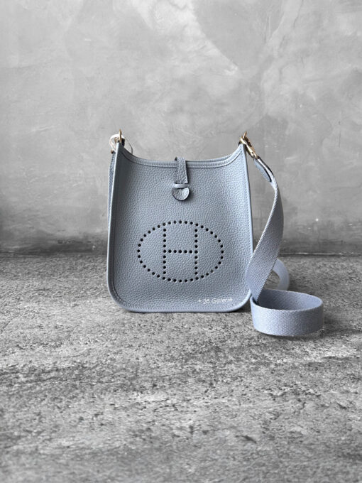 Hermès Bleu Glacier Evelyne 16 Amazone Bag, a compact crossbody in Clemence leather with signature perforated H logo and canvas strap.