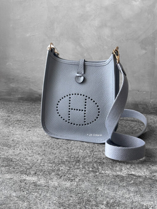 Hermès Bleu Glacier Evelyne 16 Amazone Bag, a compact crossbody in Clemence leather with signature perforated H logo and canvas strap.