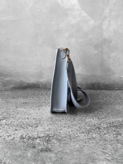 Hermès Bleu Glacier Evelyne 16 Amazone Bag, a compact crossbody in Clemence leather with signature perforated H logo and canvas strap.