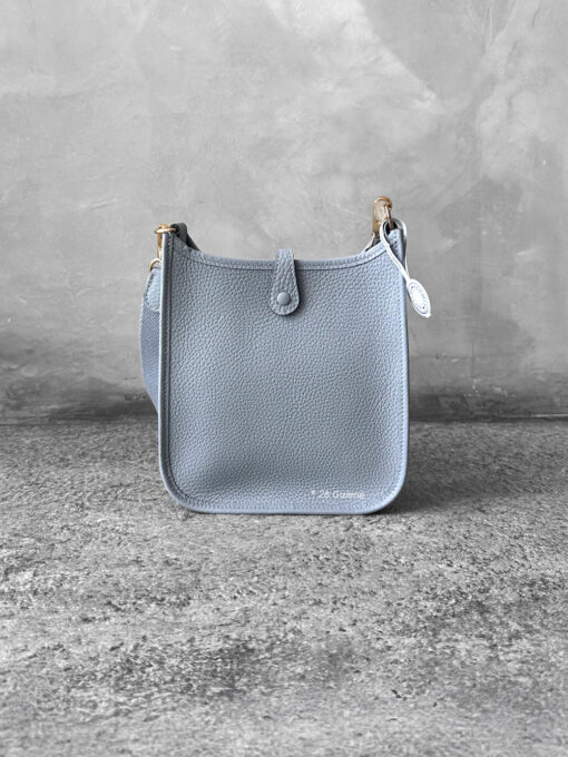 Hermès Bleu Glacier Evelyne 16 Amazone Bag, a compact crossbody in Clemence leather with signature perforated H logo and canvas strap.