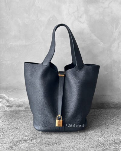 Hermès Noir Picotin in Clemence leather with gold hardware, a classic and elegant bucket-style tote crafted with signature Hermès refinement.