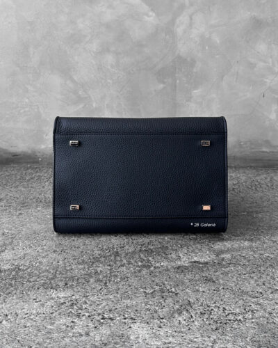 The Row Black Soft Margaux Top-handle bag in matte grained calfskin leather with belted gusseted side panels and interior toggle closure