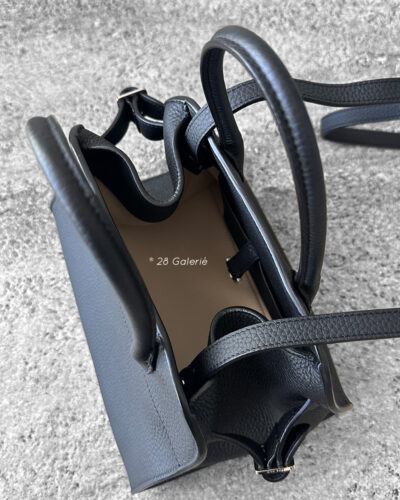 The Row Black Soft Margaux Top-handle bag in matte grained calfskin leather with belted gusseted side panels and interior toggle closure