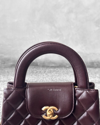 Chanel Dark Brown Mini Kelly Shopping Tote in shiny calfskin leather with gold hardware. A chic, structured design that blends elegance with everyday style.