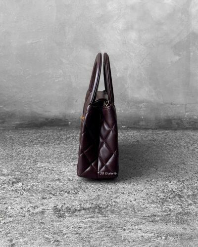 Chanel Dark Brown Mini Kelly Shopping Tote in shiny calfskin leather with gold hardware. A chic, structured design that blends elegance with everyday style.