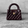 Chanel Dark Brown Mini Kelly Shopping Tote in shiny calfskin leather with gold hardware. A chic, structured design that blends elegance with everyday style.