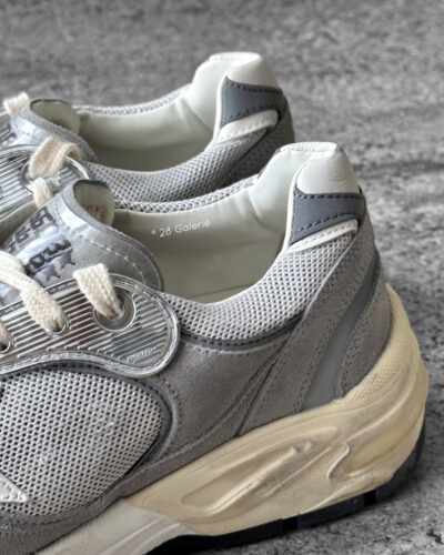 Golden Goose Dad-Star sneakers in suede and silver mesh, combining retro-inspired style with signature distressed detailing.