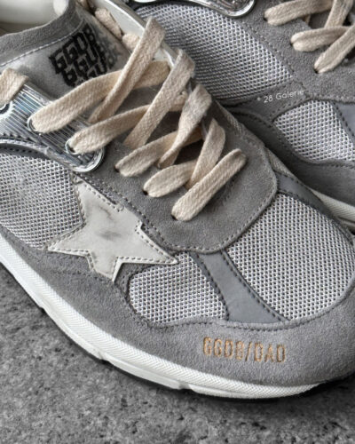 Golden Goose Dad-Star sneakers in suede and silver mesh, combining retro-inspired style with signature distressed detailing.