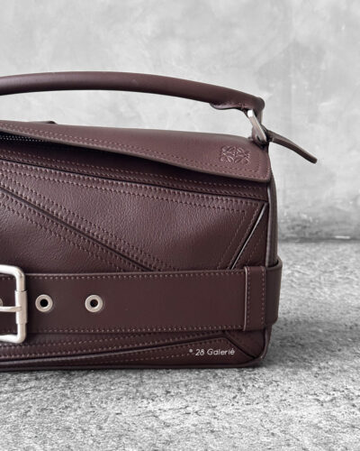 Loewe Small Dark Brownie Puzzle Biker Bag in calfskin leather, blending the iconic Puzzle design with bold biker-inspired detailing.