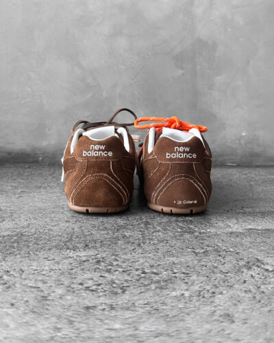 Miu Miu x New Balance 530 SL sneakers in cinnamon suede leather, merging sporty design with luxury craftsmanship.