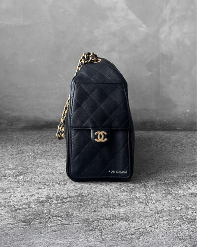 Small Black C25 Quilted Caviar bag with aged gold-tone hardware. A classic, compact design that exudes timeless elegance and versatile style.