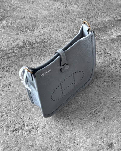 Hermès Bleu Glacier Evelyne 16 Amazone Bag, a compact crossbody in Clemence leather with signature perforated H logo and canvas strap.