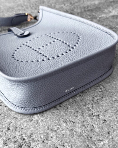 Hermès Bleu Glacier Evelyne 16 Amazone Bag, a compact crossbody in Clemence leather with signature perforated H logo and canvas strap.