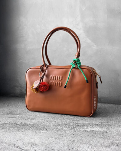 Miu Miu Cognac Large Leather Beau Bag, a structured and spacious design that blends timeless elegance with modern sophistication.