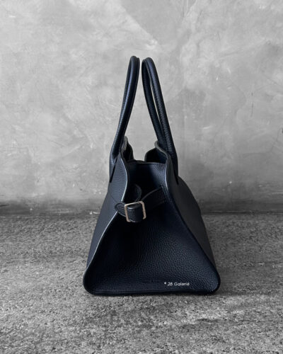 The Row Black Soft Margaux Top-handle bag in matte grained calfskin leather with belted gusseted side panels and interior toggle closure