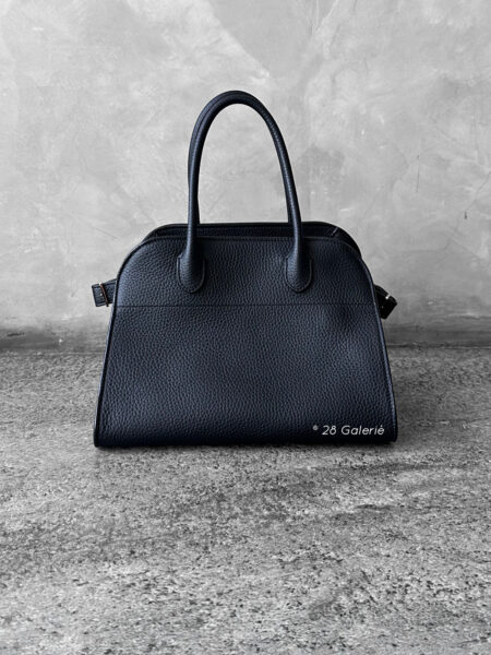 The Row Black Soft Margaux Top-handle bag in matte grained calfskin leather with belted gusseted side panels and interior toggle closure