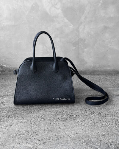 The Row Black Soft Margaux Top-handle bag in matte grained calfskin leather with belted gusseted side panels and interior toggle closure