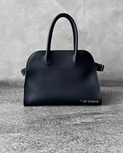 The Row Black Soft Margaux Top-handle bag in matte grained calfskin leather with belted gusseted side panels and interior toggle closure